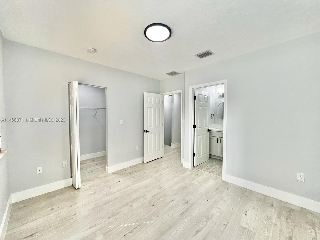 14116 Southwest 260th Street, Unit 106 Homestead, FL 33032 - Photo 16 of 24 a view of empty room with wooden floor