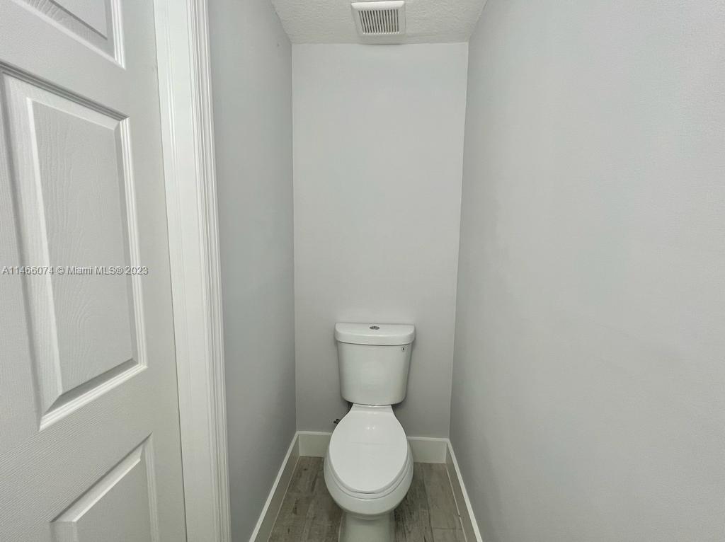 14116 Southwest 260th Street, Unit 106 Homestead, FL 33032 - Photo 18 of 24 a white toilet sitting in a bathroom