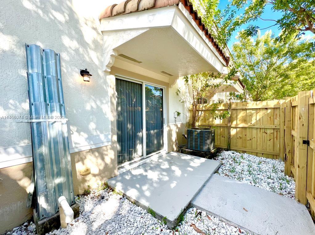 14116 Southwest 260th Street, Unit 106 Homestead, FL 33032 - Photo 19 of 24 a view of a house with a backyard