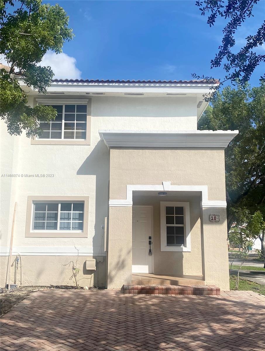 14116 Southwest 260th Street, Unit 106 Homestead, FL 33032 - Photo 2 of 24 a front view of a house