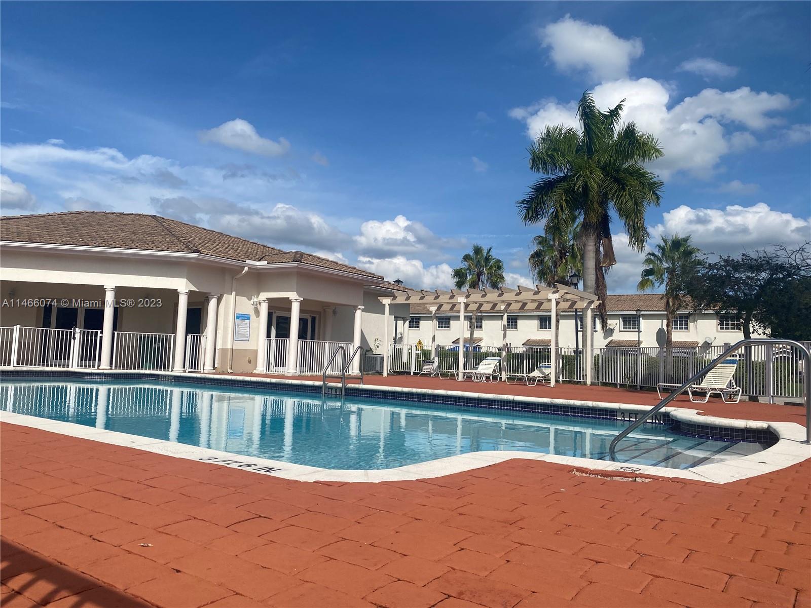14116 Southwest 260th Street, Unit 106 Homestead, FL 33032 - Photo 21 of 24 a view of a house with a yard