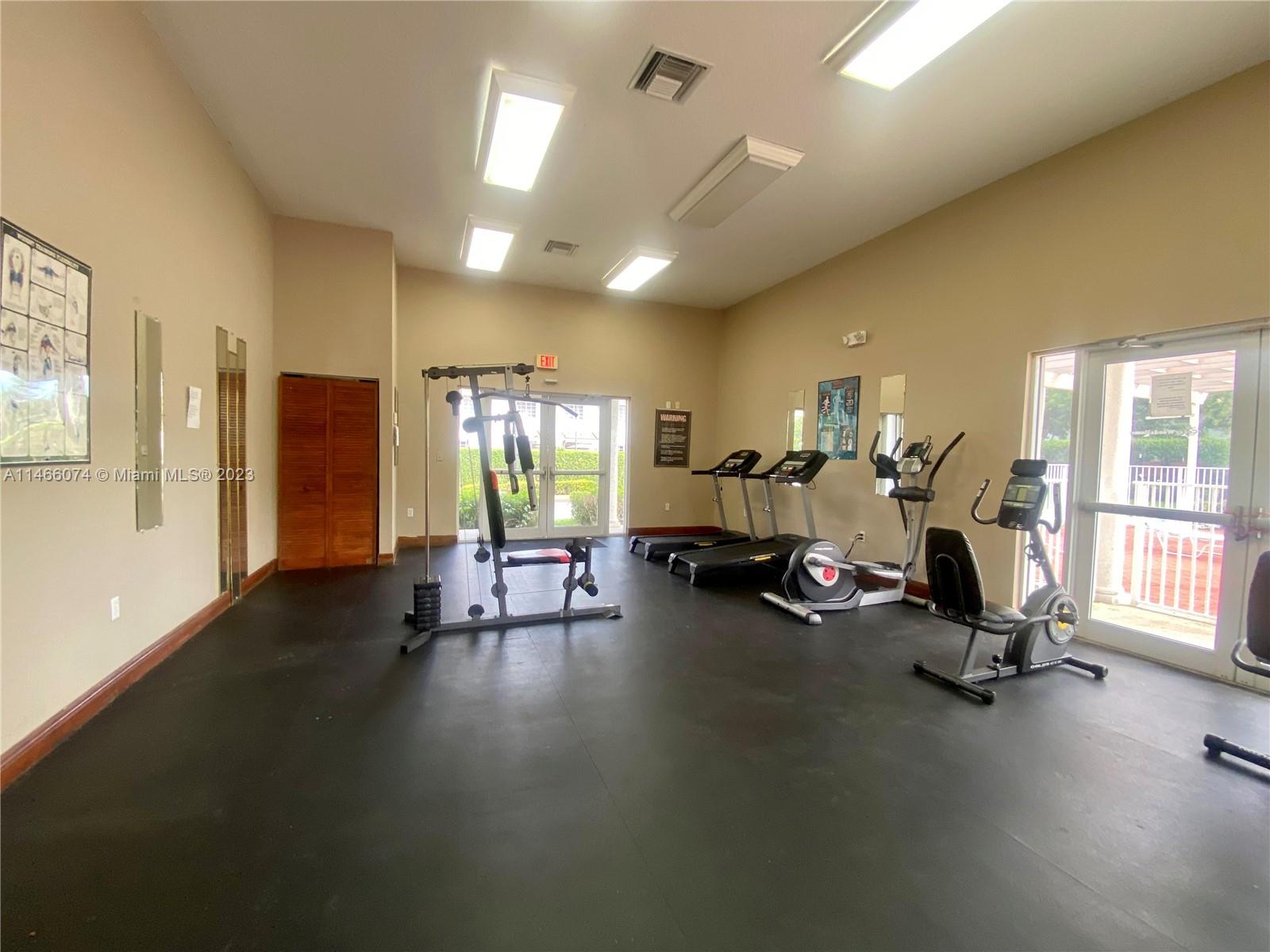 14116 Southwest 260th Street, Unit 106 Homestead, FL 33032 - Photo 23 of 24 a view of a room with gym equipment