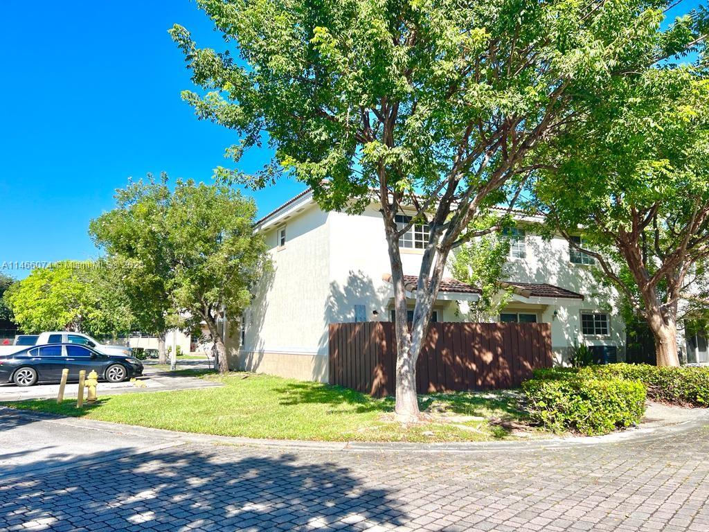 14116 Southwest 260th Street, Unit 106 Homestead, FL 33032 - Photo 3 of 24 a view of a yard with plants and trees