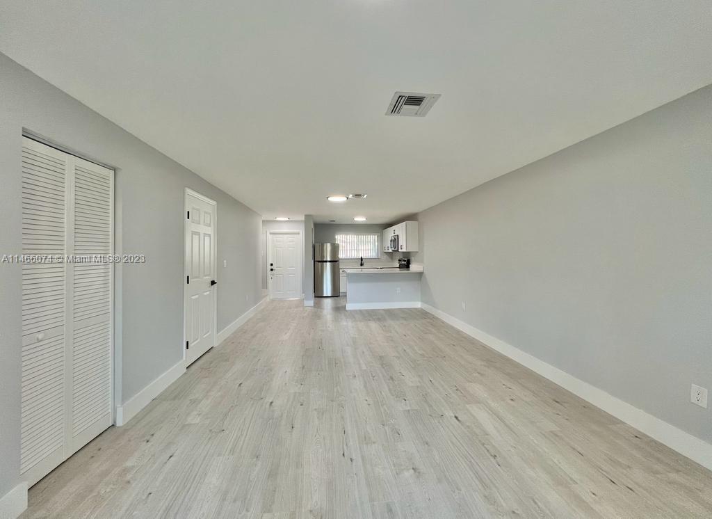 14116 Southwest 260th Street, Unit 106 Homestead, FL 33032 - Photo 6 of 24 a view of a livingroom with wooden floor