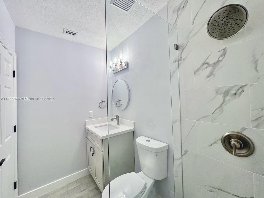 14116 Southwest 260th Street, Unit 106 Homestead, FL 33032 - Photo 9 of 24 a bathroom with a toilet and a sink