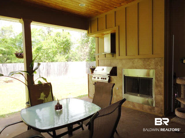 9051 Krystal Ridge Court Daphne, AL 36526 - Photo 26 of 28 Covered patio with gas fireplace & grill.