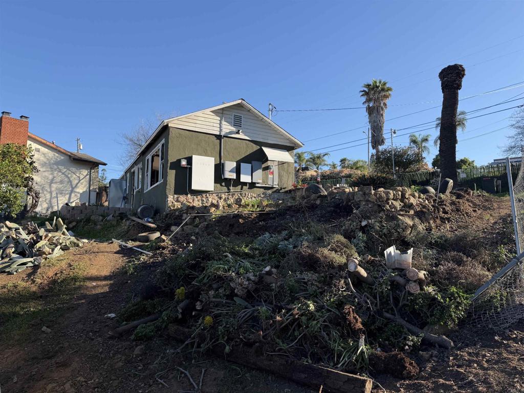 1726 Helix Street Spring Valley, CA 91977 - Photo 7 of 7 a front view of a house with a yard and mountain view in back