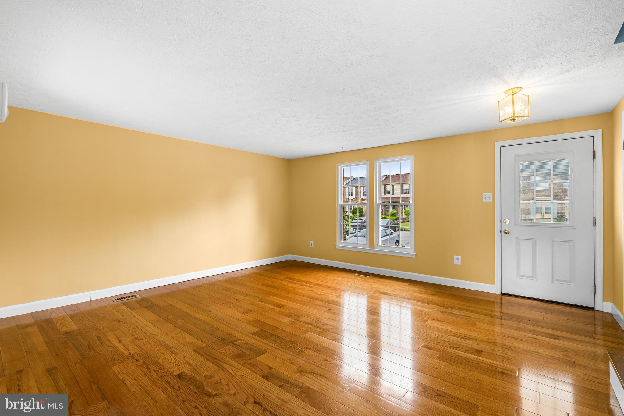3790 Timahoe Circle Baltimore, MD 21236 - Photo 5 of 33 a view of an empty room with wooden floor and a window