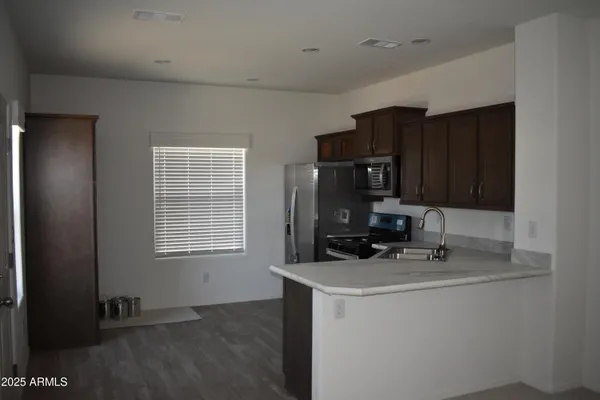 a room with cabinets and appliances
