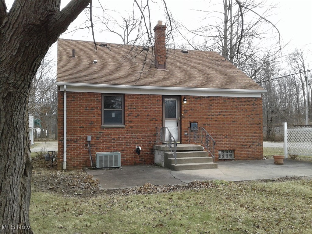 332 Claremont Road Vermilion, OH 44089 - Photo 4 of 35 Rear view of house with a patio area and central AC unit.