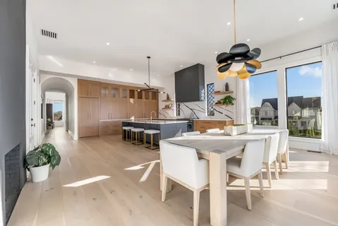 a kitchen with stainless steel appliances cabinets and a chandelier