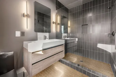 a bathroom with a toilet a sink and mirror