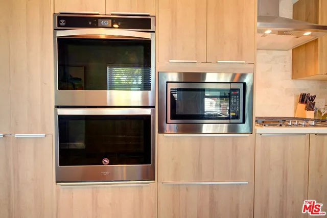 a stove top oven sitting inside of a kitchen