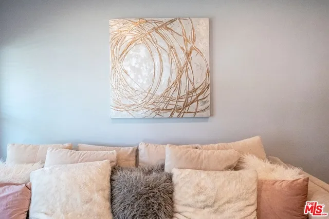 a white bed sitting in a bedroom next to a window