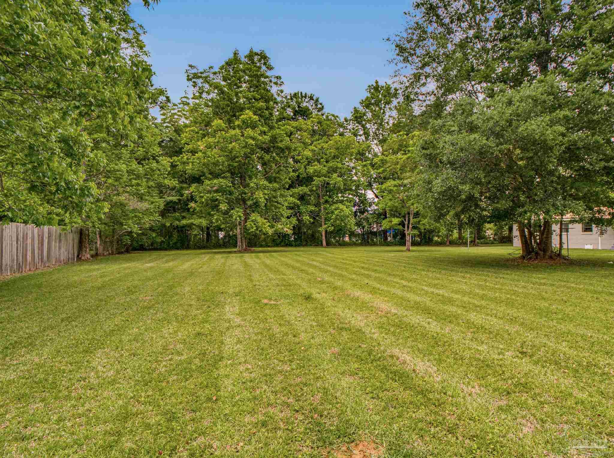125 Madrid Road Cantonment, FL 32533 - Photo 15 of 16 a view of outdoor space with deck and yard