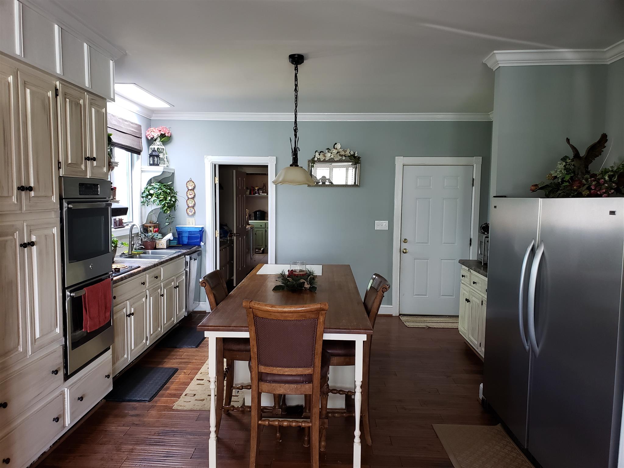 2436 Morrison Viola Road Morrison, TN 37357 - Photo 4 of 28 a kitchen with stainless steel appliances granite countertop a refrigerator a stove a sink dishwasher a dining table and chairs with wooden floor
