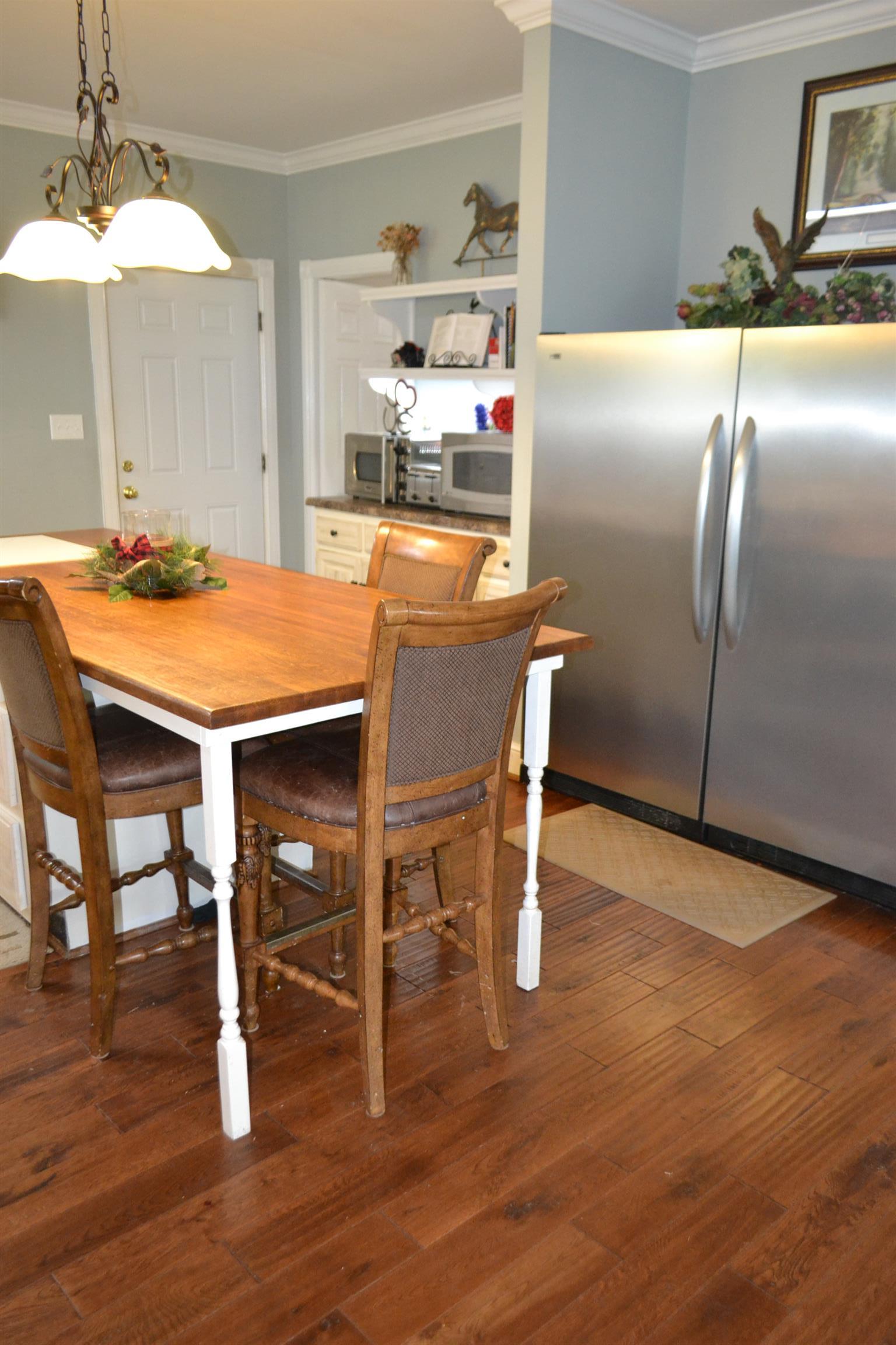 2436 Morrison Viola Road Morrison, TN 37357 - Photo 6 of 28 a room with stainless steel appliances kitchen island granite countertop a dining table chairs and a refrigerator