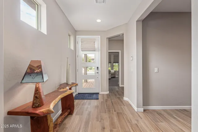 a view of a hallway with wooden floor and closet