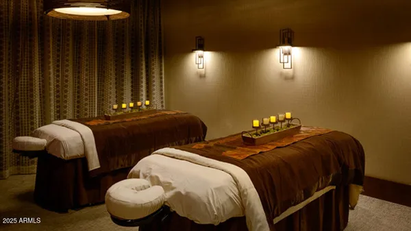 a bedroom with two beds and painting on the wall