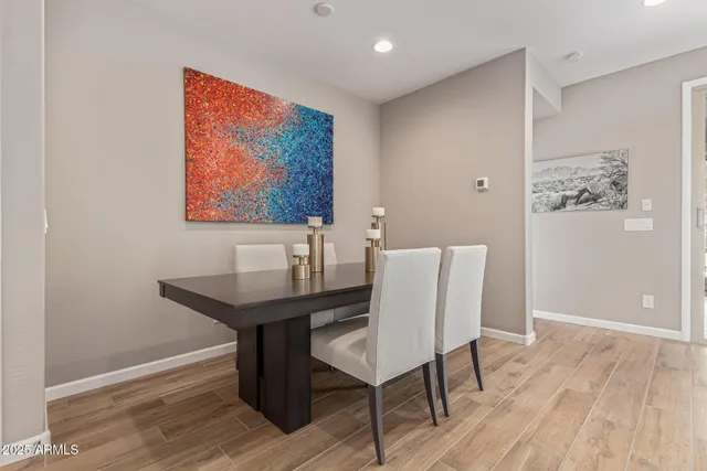 a view of a workspace with furniture and wooden floor