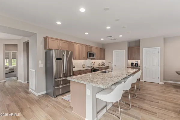 a kitchen with stainless steel appliances granite countertop a refrigerator and microwave