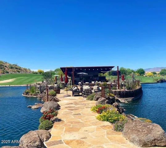 a view of a lake with couches and city view