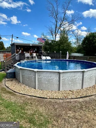 a view of a swimming pool with outdoor seating