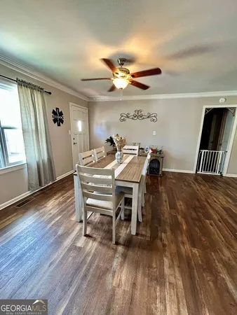 a view of a dining room with furniture and wooden floor