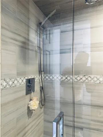a bathroom with a glass shower door