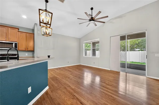 a view of a kitchen with kitchen island and stainless steel appliances