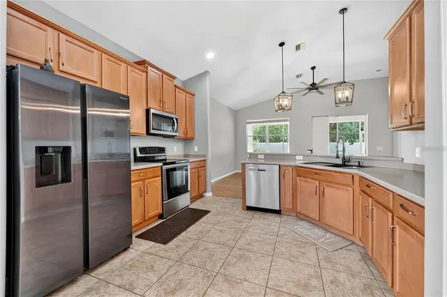 a kitchen with stainless steel appliances granite countertop a refrigerator stove and microwave