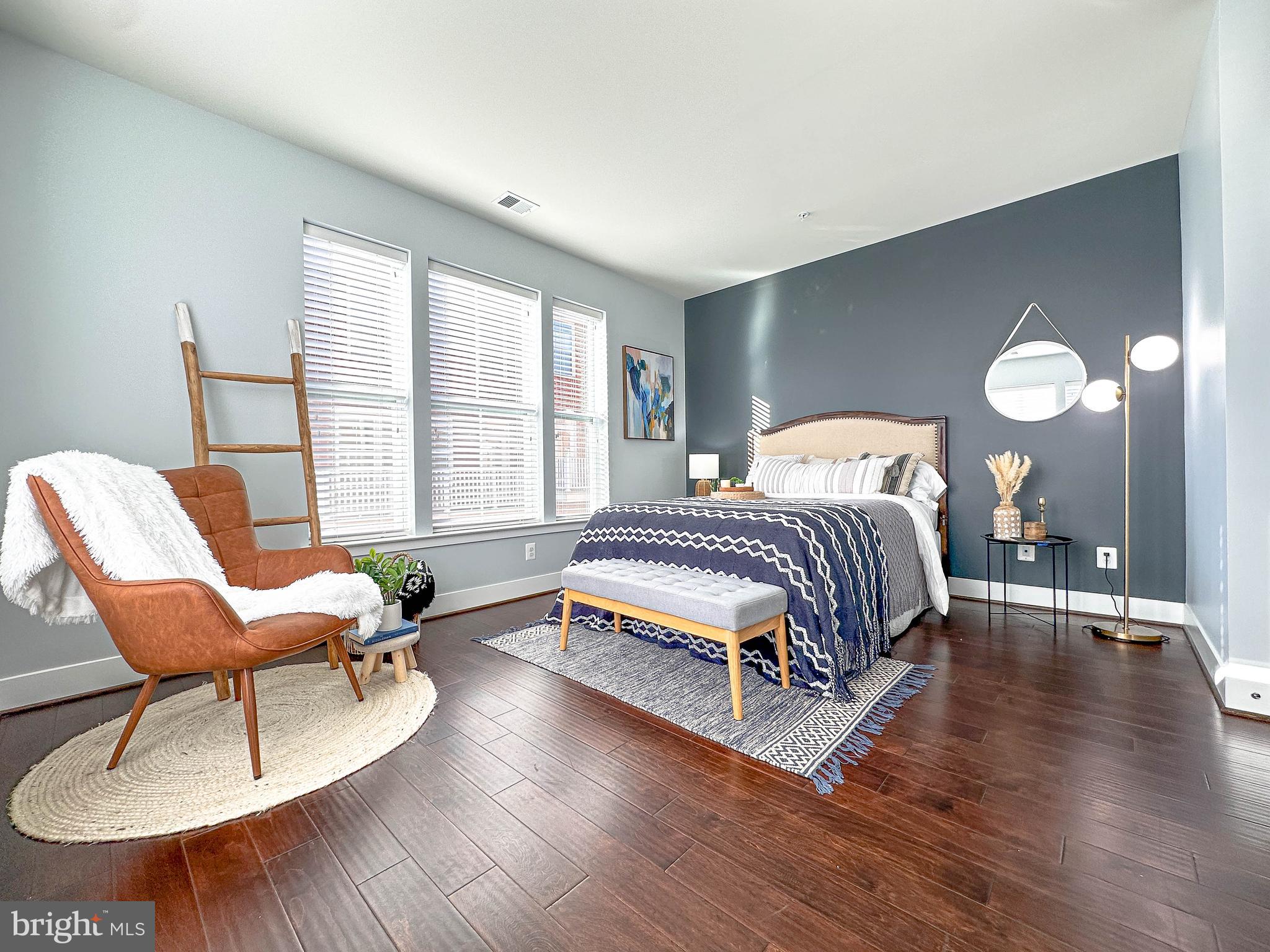 1951 Reston Vly Way, Unit 7 Reston, VA 20191 - Photo 13 of 37 a bedroom with a bed a chair and a large window