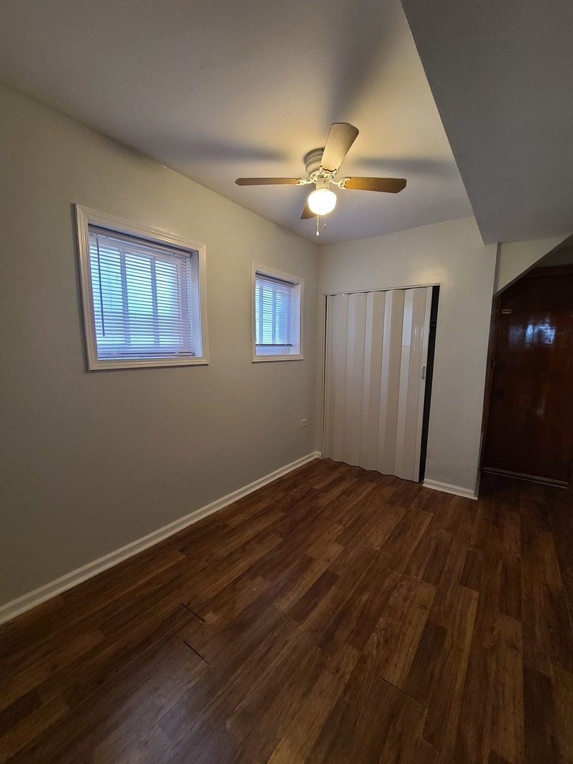 1531 West Highland Avenue, Unit 1 Chicago, IL 60660 - Photo 12 of 14 a view of an empty room with wooden floor and a ceiling fan