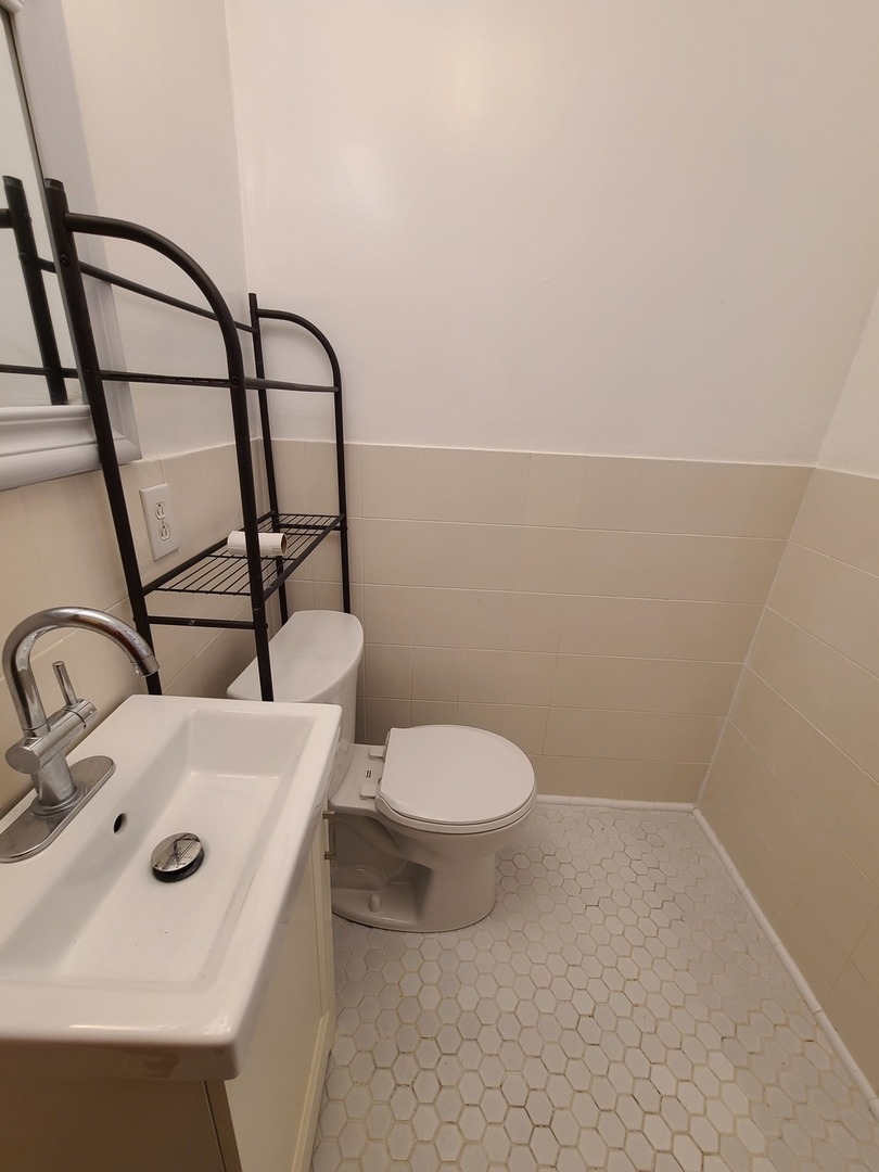 1531 West Highland Avenue, Unit 1 Chicago, IL 60660 - Photo 13 of 14 a bathroom with a sink a toilet and mirror