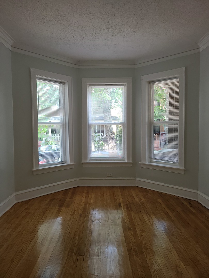 1531 West Highland Avenue, Unit 1 Chicago, IL 60660 - Photo 2 of 14 a view of empty room with wooden floor and fan