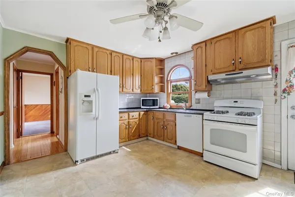 a kitchen with a refrigerator a sink and cabinets