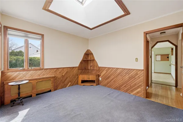 a living room with a couch and a dresser next to a window