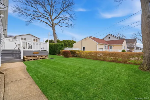 a view of house with garden and tall trees