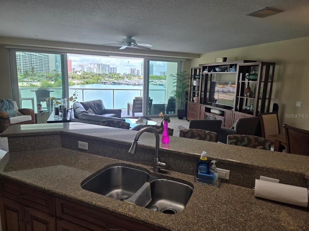 650 Golden Gate Point, Unit 301 Sarasota, FL 34236 - Photo 17 of 31 a kitchen with a sink and a large window