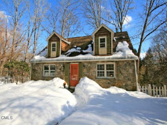 a view of a house with a yard covered with snow