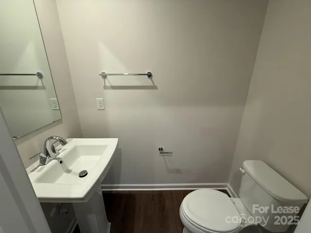 a bathroom with a sink a toilet and mirror