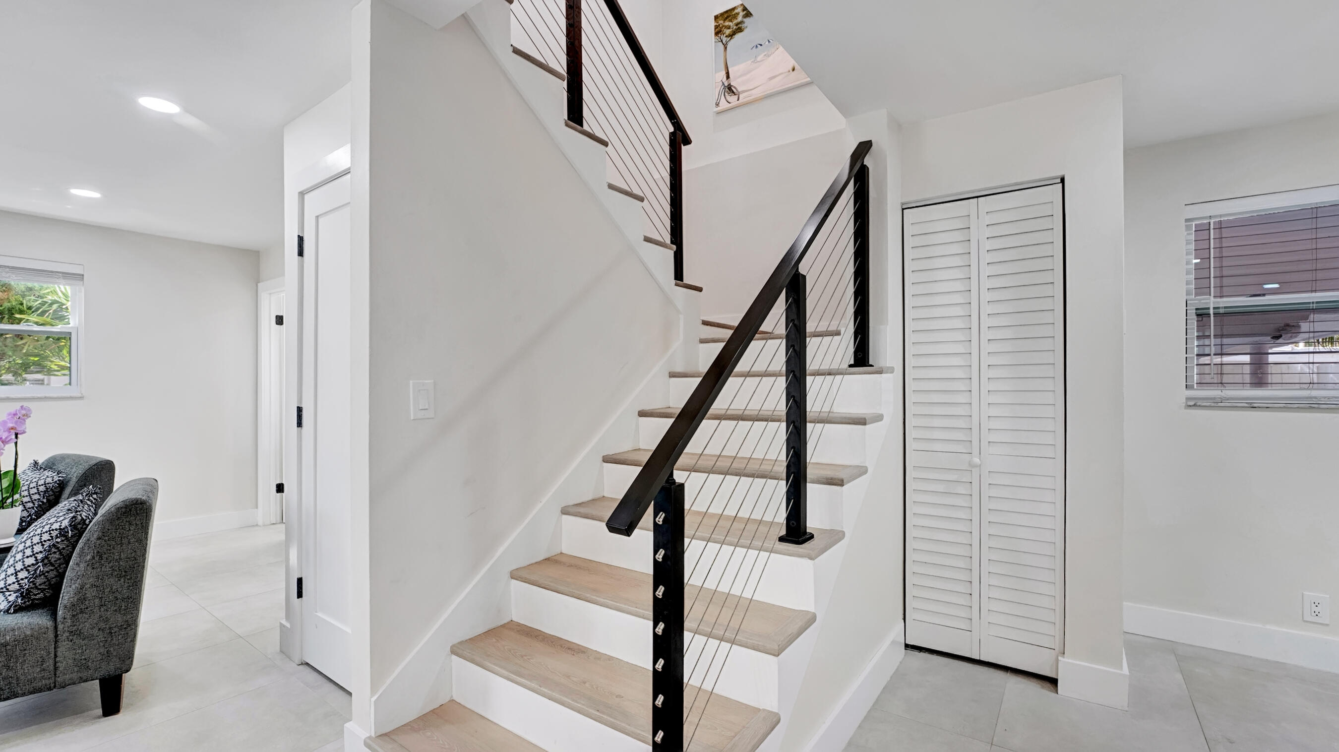 218 Northeast 10th Street Delray Beach, FL 33444 - Photo 13 of 43 a view of entryway with wooden floor and stairs
