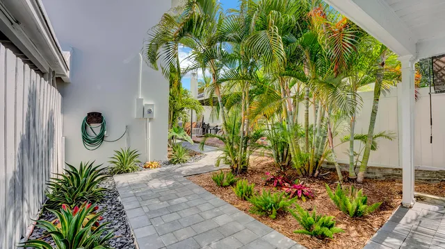 a front view of a house with a lot of potted plants