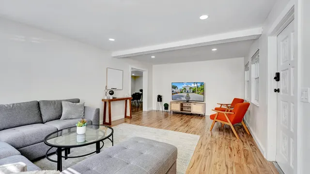 a view of a dining room with furniture and wooden floor