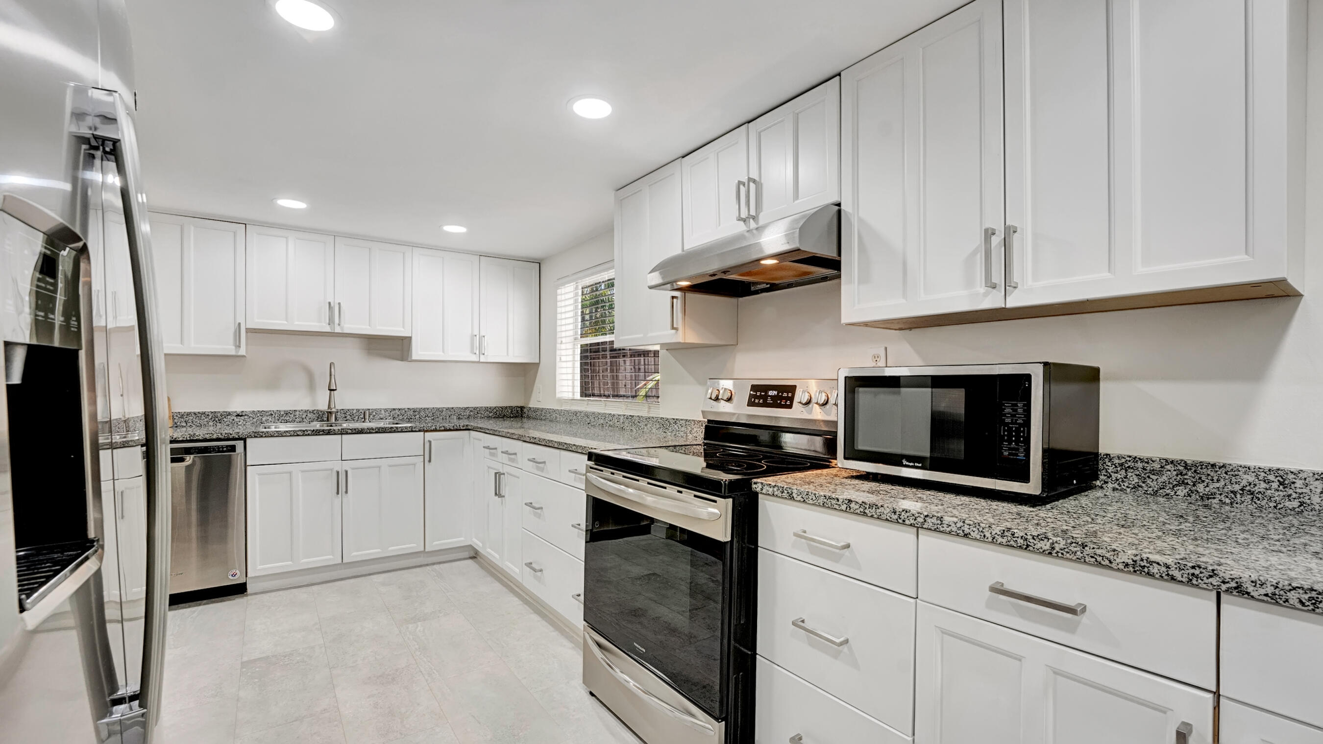 218 Northeast 10th Street Delray Beach, FL 33444 - Photo 33 of 43 a kitchen with granite countertop white cabinets stainless steel appliances and a sink
