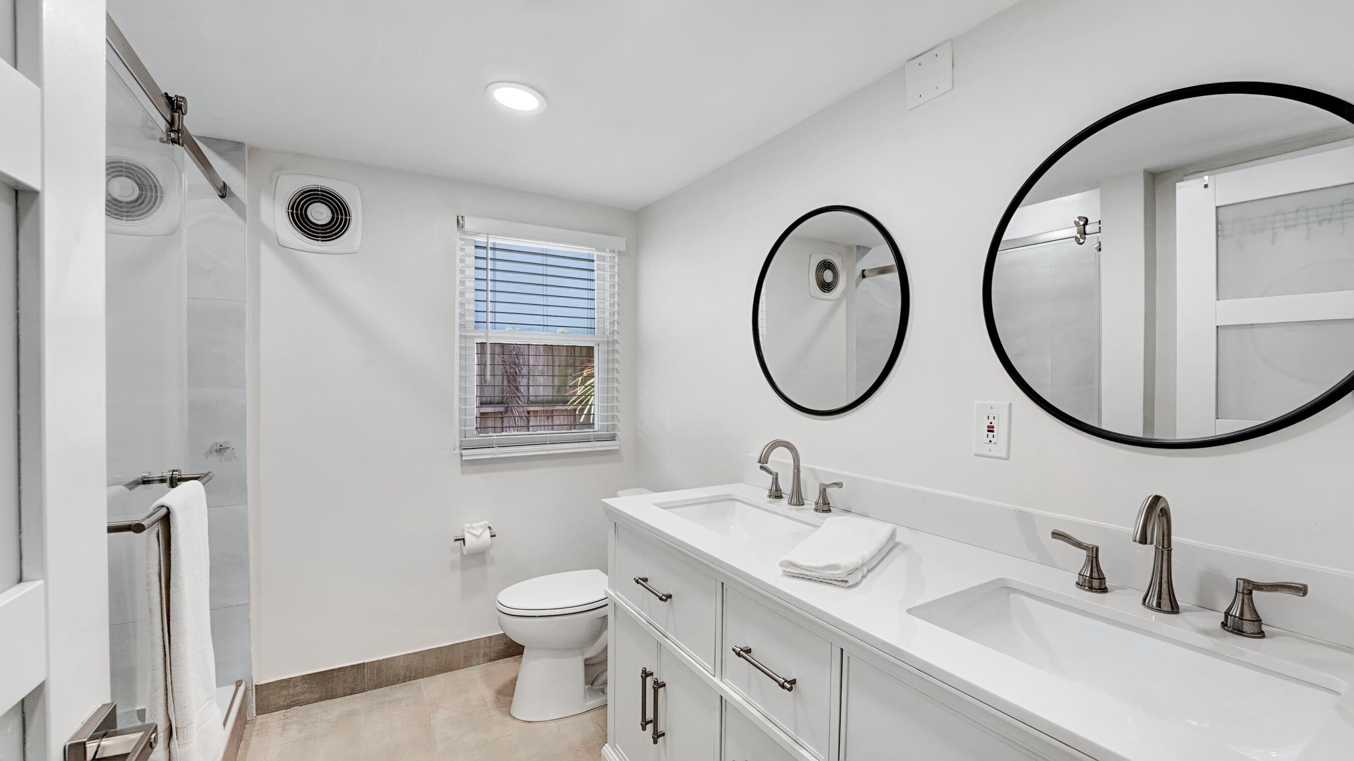 218 Northeast 10th Street Delray Beach, FL 33444 - Photo 34 of 43 a bathroom with a granite countertop toilet a sink and a mirror