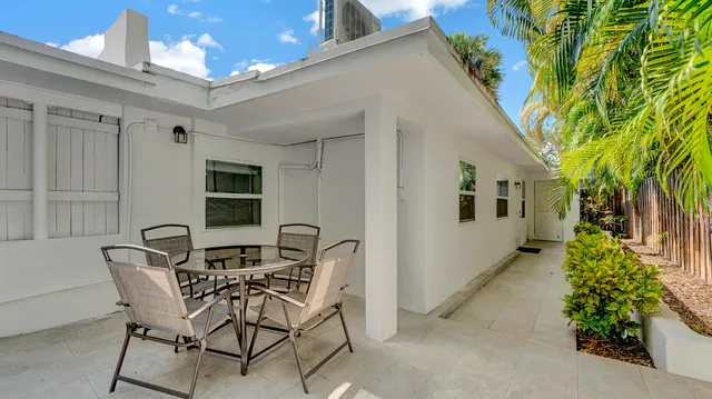 an aerial view of a house with a garden and a yard