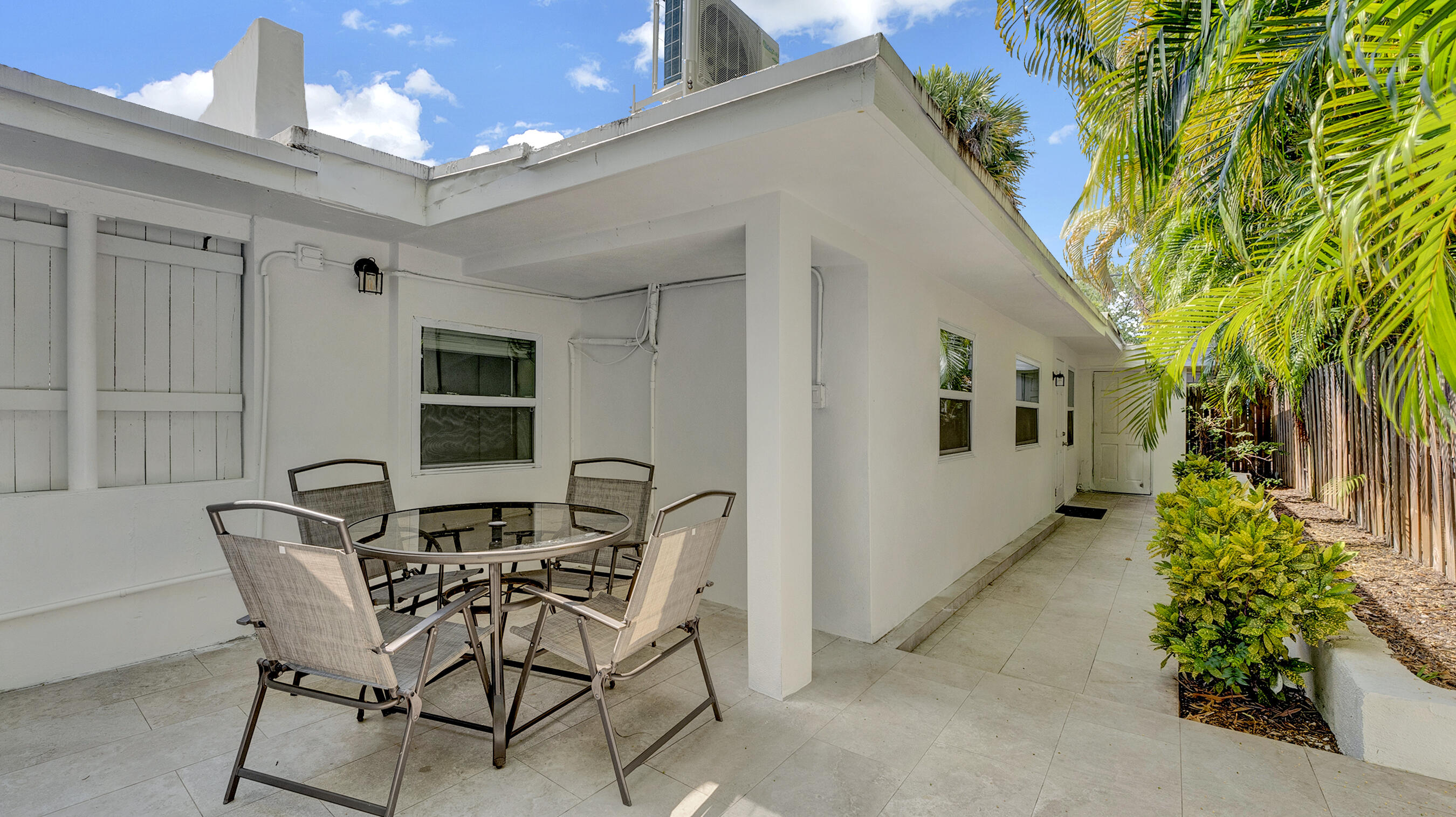 218 Northeast 10th Street Delray Beach, FL 33444 - Photo 39 of 43 a view of a patio with table and chairs and potted plants