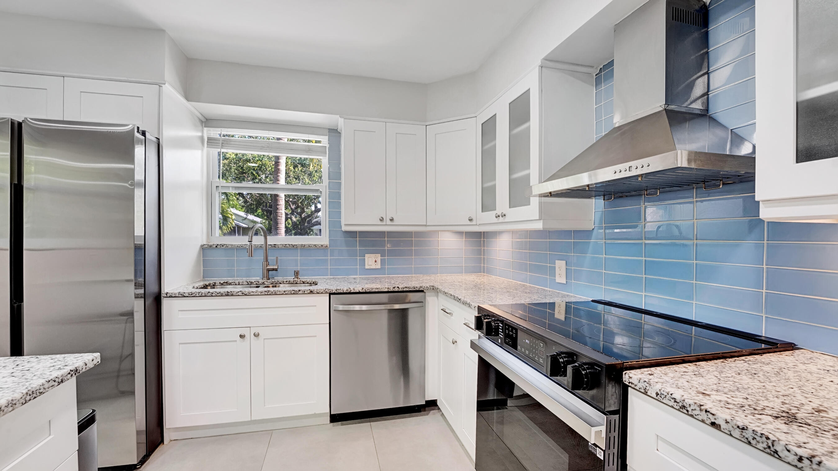 218 Northeast 10th Street Delray Beach, FL 33444 - Photo 8 of 43 a kitchen with a sink stove and cabinets