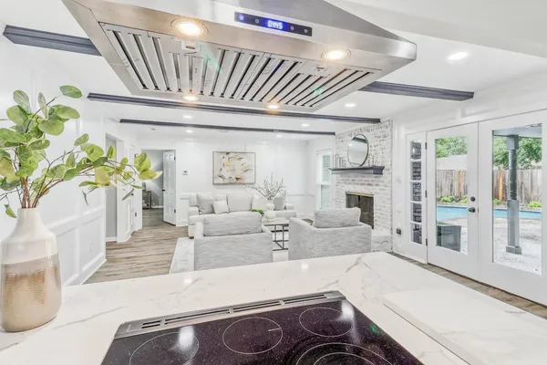 a living room with fireplace furniture and a potted plant